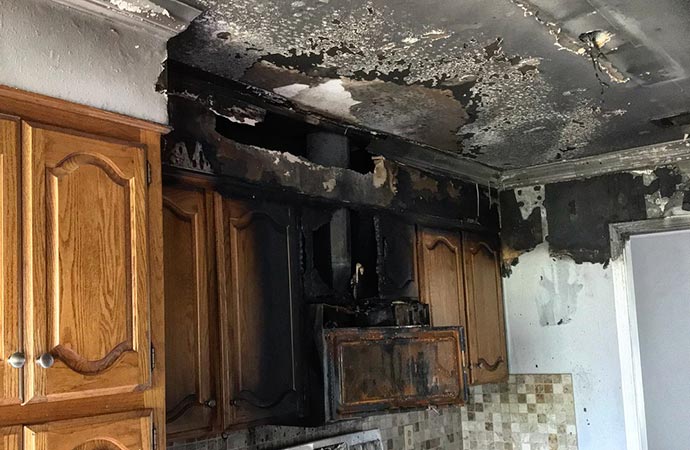 A kitchen with severe soot damage